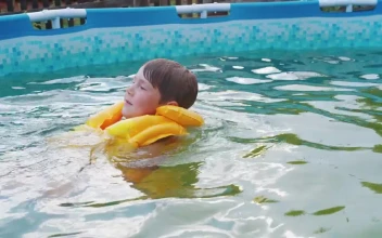 Stock Footage Young Boy With Inflatable Vest Swimming In The Pool Free