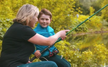 Stock Footage Woman Teaching A Boy To Fish Free
