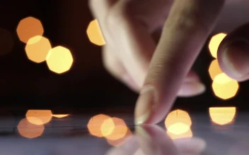 Stock Footage Womans Finger Scrolling Tablet Surface With Bokeh Backgound Free
