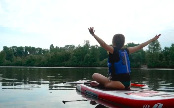 Stock Footage Woman Does Yoga Routine On Paddle Board In River Free