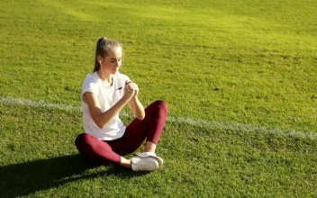 Stock Footage Young Runner Does Stretch Routine On Track Field Free