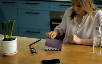 Stock Footage Young Woman Writing On A Notebook In The Kitchen Free