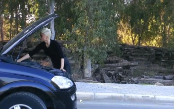 Stock Footage Woman Trying To Fix Her Car Engine Free
