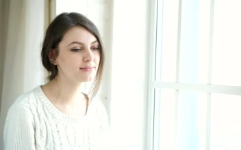Stock Footage Young Woman Sips Tea Near Bright Sunny Window Free