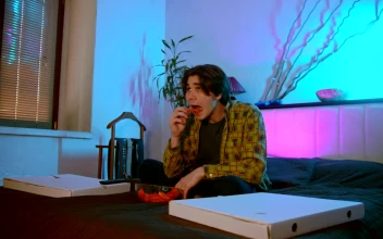 Stock Footage Young Man Eating Snacks While Watching A Movie Free