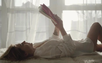 Stock Footage Woman Enjoys Reading Hobby By Sunny Window Free