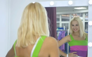 Stock Footage Woman Poses In Front Of Dressing Room Mirror Free