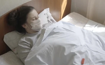 Stock Footage Woman In Face Mask Checks Thermometer While In Bed Free