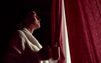 Stock Footage Woman Sips Coffee And Looks Through Curtains In Lockdown Free