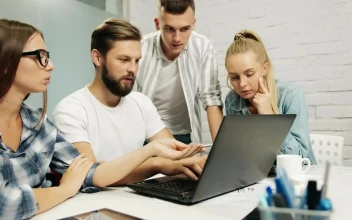 Stock Footage Young Marketing Team Gather Around Laptop Free