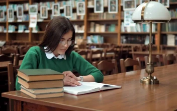 Stock Footage Young Woman Learning In Library Smiles At Camera Free