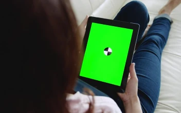 Stock Footage Woman Looks At Website With Chroma Key Tablet On Sofa Free