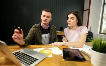 Stock Footage Young Man Explains Idea To Partner And Points To Laptop Free