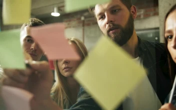 Stock Footage Young Team Brainstorms Ideas With Sticky Notes Free