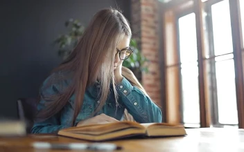 Stock Footage Young Student Reading A Book In Sunlit Room Free
