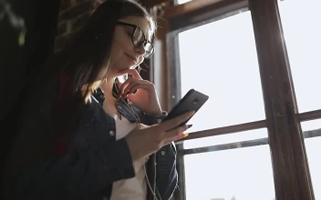 Stock Footage Young Girl Smiles At Facebook Post On Mobile Phone Free