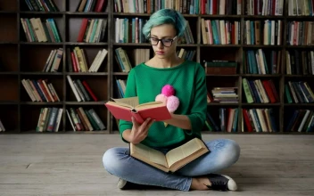 Stock Footage Woman With Glasses Reading In The Library Free