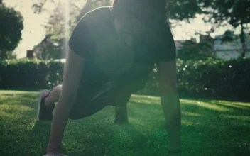 Stock Footage Young Woman Doing Push Ups On The Grass In A Park Free