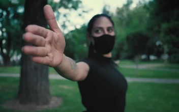 Stock Footage Woman With Face Mask Stretching With Her Arms In A Free
