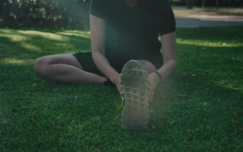 Stock Footage Woman Sitting In A Park Stretching Her Body Free