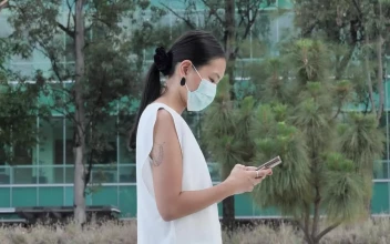 Stock Footage Woman With Face Mask Walking While Texting Free