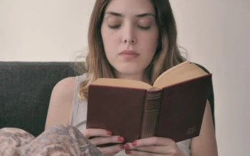 Stock Footage Young Woman Lying On A Sofa Reading A Book Free