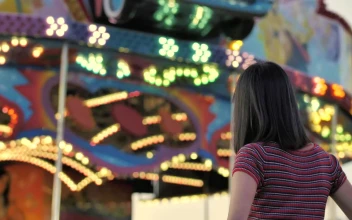 Stock Footage Woman From The Back Looking Towards A Mechanical Game With Free