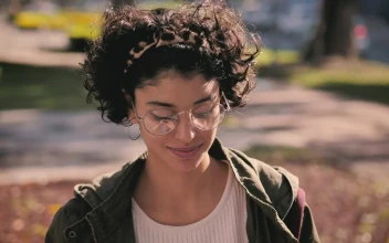 Stock Footage Woman Putting On Headphones In The Park Free