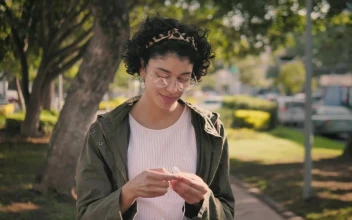 Stock Footage Woman Putting On Headphones While Going For A Walk Free