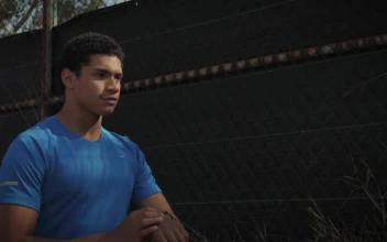 Stock Footage Young Man Jogging In Front Of Chainlink Fence Free