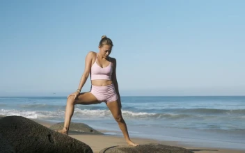 Stock Footage Woman Doing Yoga On Boulders On The Beach Free