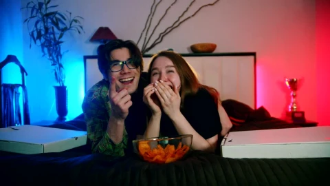 Stock Video A Boy And A Girl Laughing While Watching Television Live Wallpaper for PC - Free Live Wallpaper