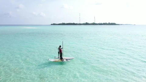 Stock Video A Couple Paddling On Boards On Turquoise Sea Live Wallpaper for PC - Free Live Wallpaper