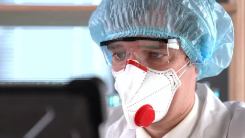 Stock Video A Doctor Wearing A Face Mask And Protection Glasses Live Wallpaper for PC - Free Live Wallpaper