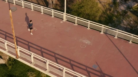 Stock Video Aerial Shot Of A Girl Jogging On A Footbridge Live Wallpaper for PC - Free Live Wallpaper