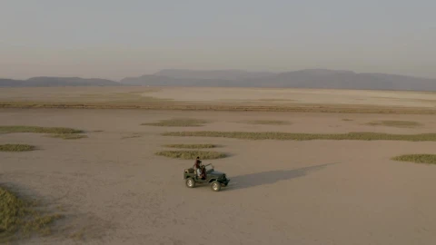 Stock Video Aerial Shot Of A Jeep Truck Traveling Through A Desert Live Wallpaper for PC - Free Live Wallpaper
