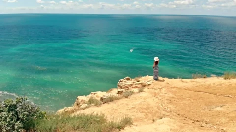 Stock Video Aerial View Of A Woman Looking Out To Sea From Live Wallpaper for PC - Free Live Wallpaper