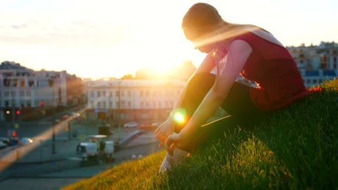 Stock Video Ballet Dancer Adjusting Her Slippers On The Grass Live Wallpaper For PC - Free Live Wallpaper