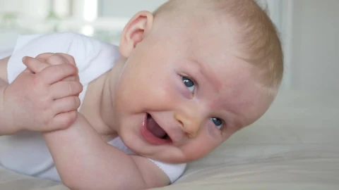 Stock Video Baby Smiles And Rolls Over In White Bedroom Live Wallpaper For PC - Free Live Wallpaper