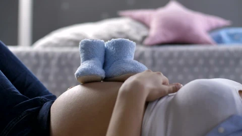 Stock Video Baby Shoes On A Womans Pregnant Belly Live Wallpaper For PC - Free Live Wallpaper