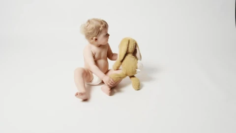 Stock Video Baby Girl With Plushie Sitting On A White Background Live Wallpaper For PC - Free Live Wallpaper