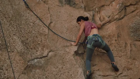 Stock Video Athletic Female Mountaineer Climbing A Rocky Mountain Live Wallpaper For PC - Free Live Wallpaper