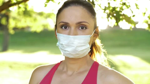 Stock Video Athlete Woman Wearing Mask In Park Portrait Live Wallpaper For PC - Free Live Wallpaper