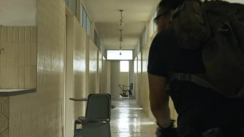 Stock Video Armed Man Securing An Area In An Empty Building Live Wallpaper For PC - Free Live Wallpaper