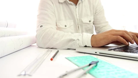 Stock Video Architect Working On Blueprints And His Laptop Live Wallpaper For PC - Free Live Wallpaper
