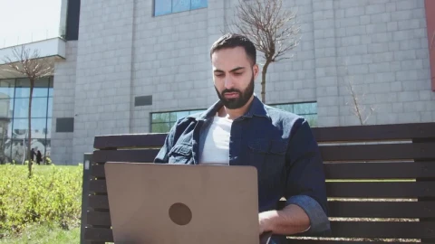 Stock Video Arab Man Works On Laptop Outside Office Building Live Wallpaper For PC - Free Live Wallpaper