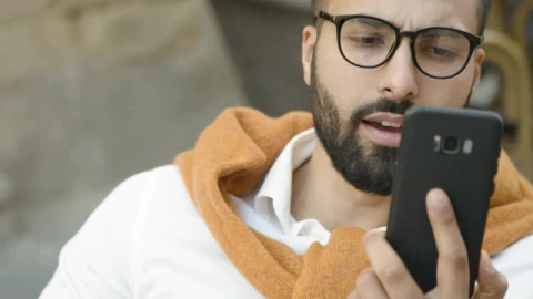 Stock Video Arab Man Smiles While Using Mobile App Live Wallpaper For PC - Free Live Wallpaper