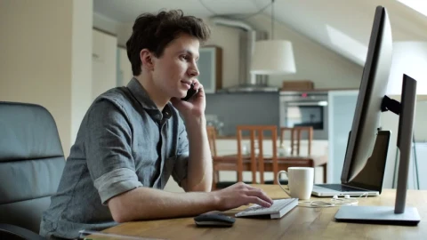 Stock Video A Young Man Talking On The Phone Working On The Live Wallpaper For PC - Free Live Wallpaper