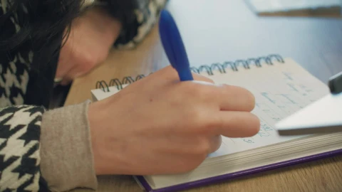 Stock Video A Woman Writing In Her Spiral Notebook Live Wallpaper For PC - Free Live Wallpaper