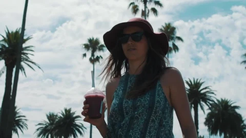 Stock Video A Woman Walking And Drinking A Smoothie Live Wallpaper For PC - Free Live Wallpaper